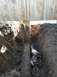Fence post thru a sewer line.