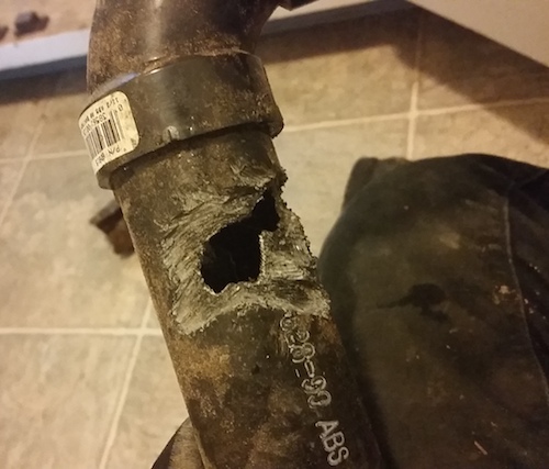 Something chewed this ABS drain pipe almost in half.
