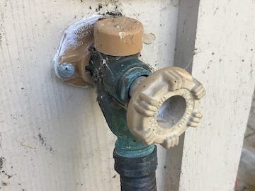 An outside faucet that will probably be damaged if it freezes.